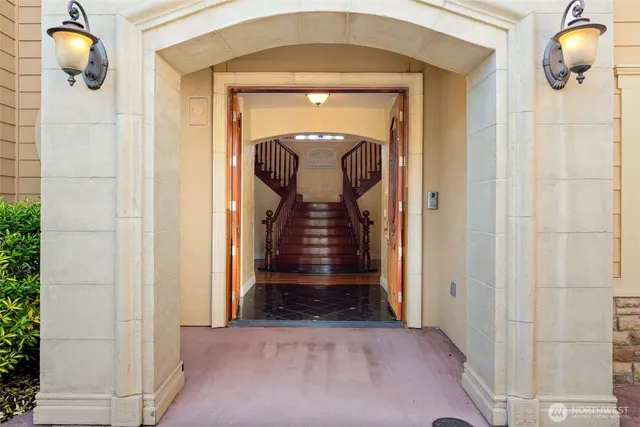 a view of staircase with wooden floor and a chandelier