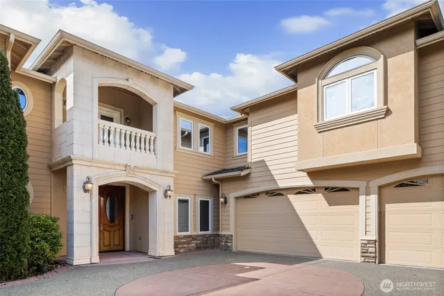a front view of a house with plants and entryway