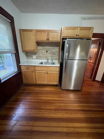 a kitchen with stainless steel appliances granite countertop a refrigerator and a sink