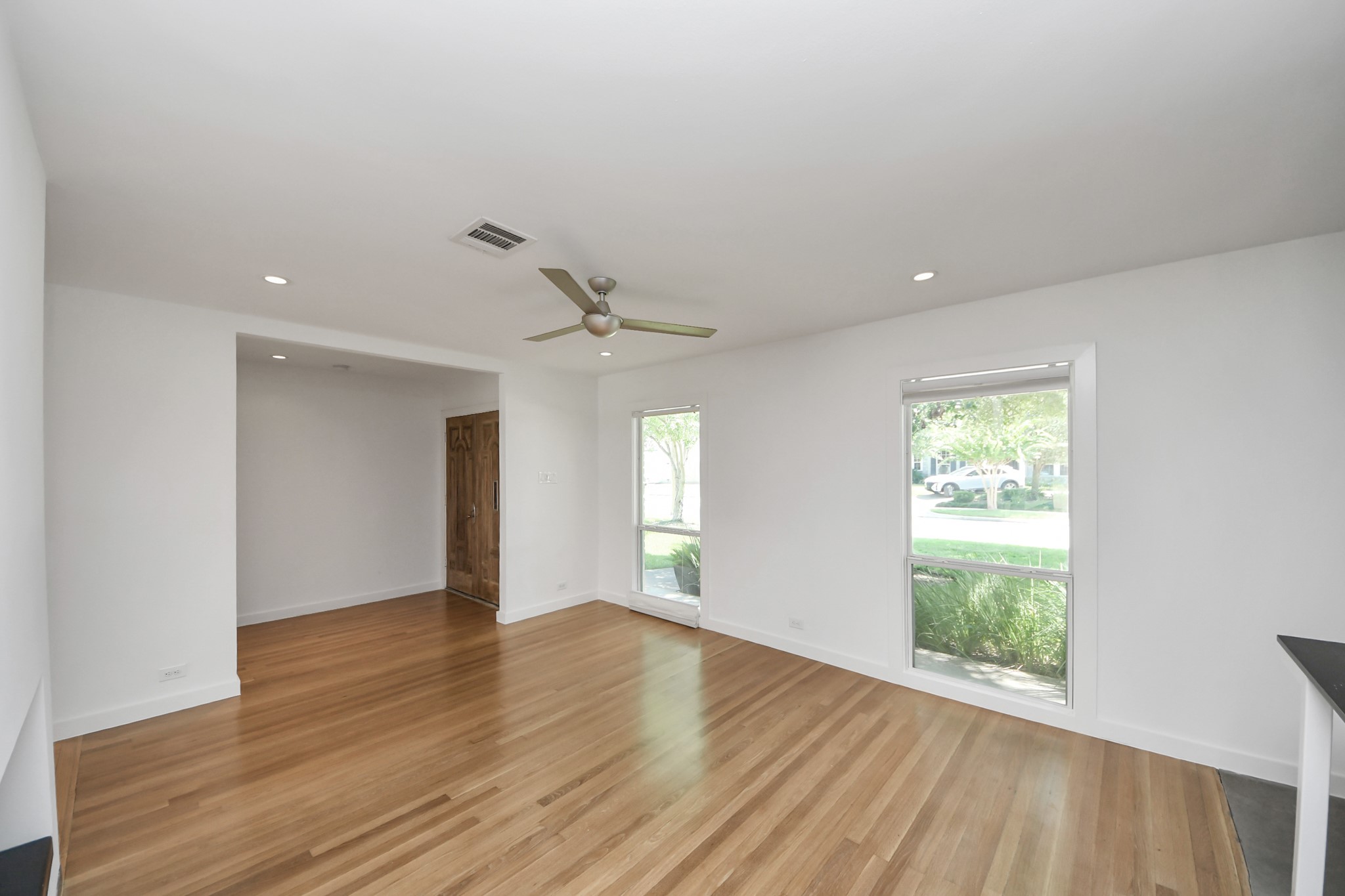 7610 Highmeadow Drive Houston, TX 77063 - Photo 13 of 50 a view of an empty room with wooden floor and a window