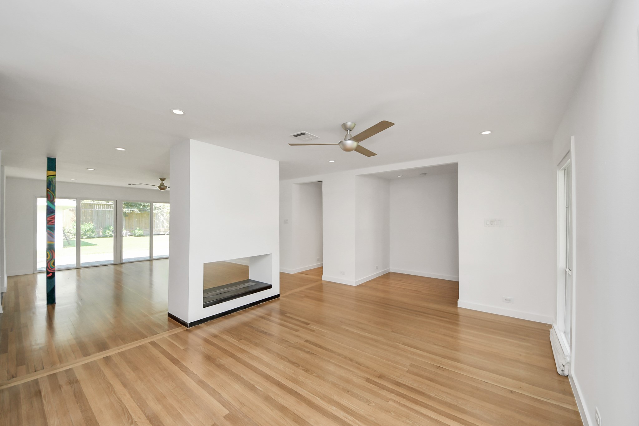 7610 Highmeadow Drive Houston, TX 77063 - Photo 16 of 50 a view of an empty room with wooden floor and a window