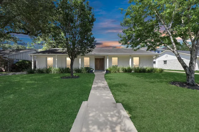 a front view of a house with yard