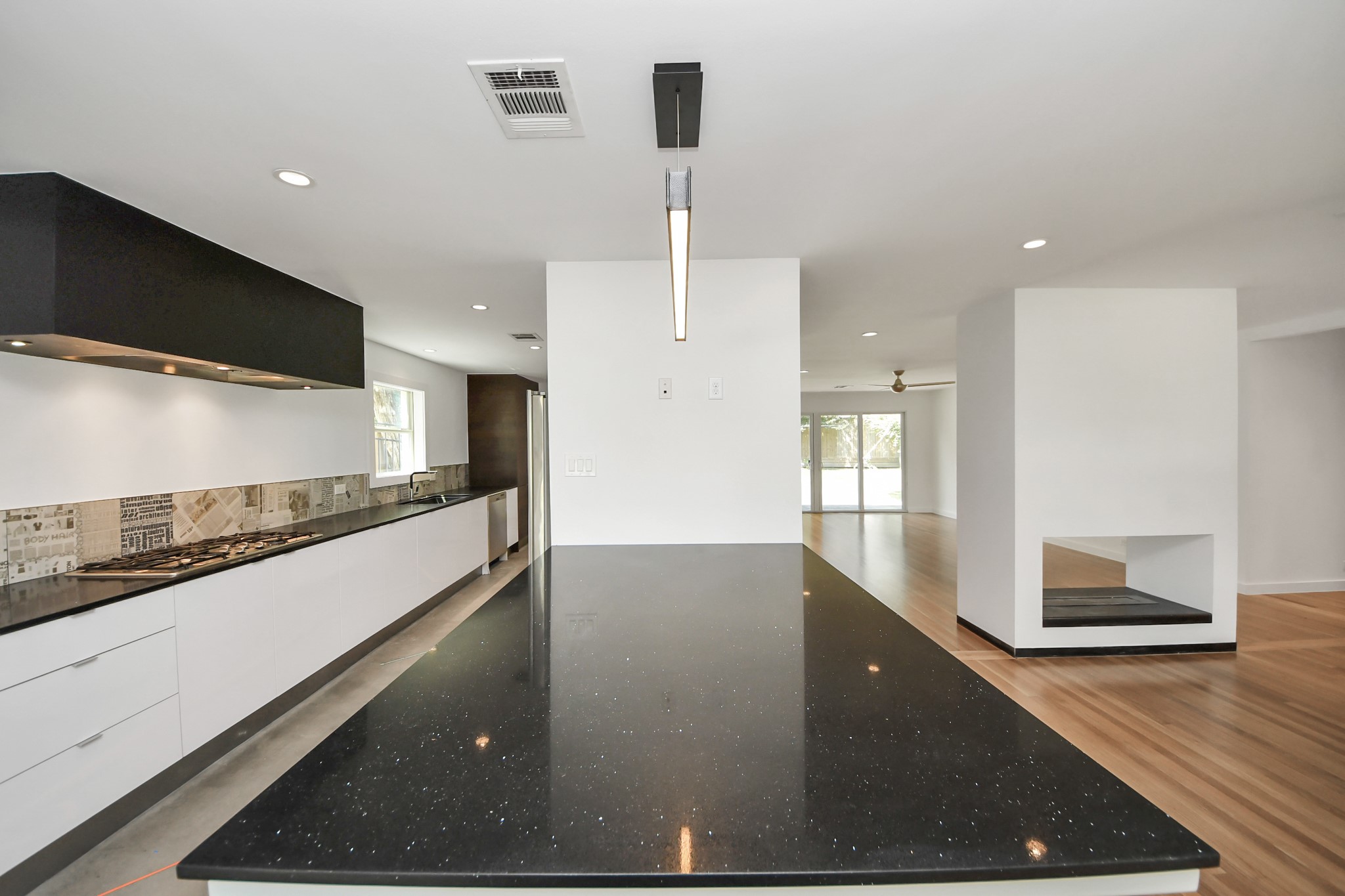 7610 Highmeadow Drive Houston, TX 77063 - Photo 23 of 50 a view of a kitchen with kitchen island a sink stainless steel appliances and a counter top space