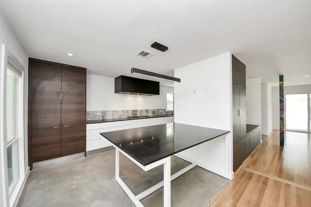 a kitchen with stainless steel appliances a microwave a stove and a refrigerator