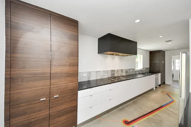 a view of kitchen with refrigerator microwave and wooden floor