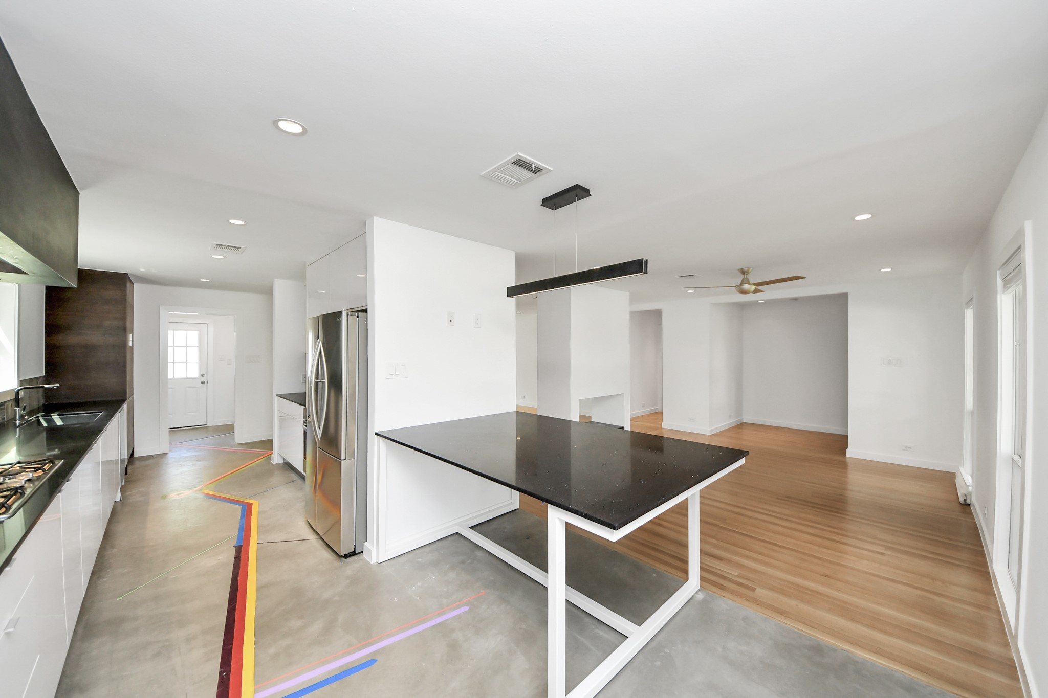 7610 Highmeadow Drive Houston, TX 77063 - Photo 27 of 50 a view of kitchen with refrigerator microwave and wooden floor