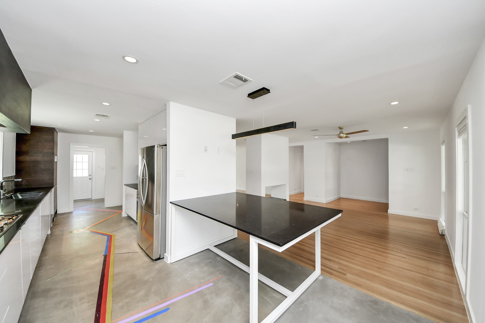 7610 Highmeadow Drive Houston, TX 77063 - Photo 28 of 50 a view of kitchen with refrigerator microwave and wooden floor