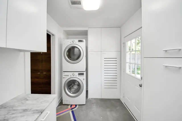 a bathroom with a bathtub sink mirror and toilet