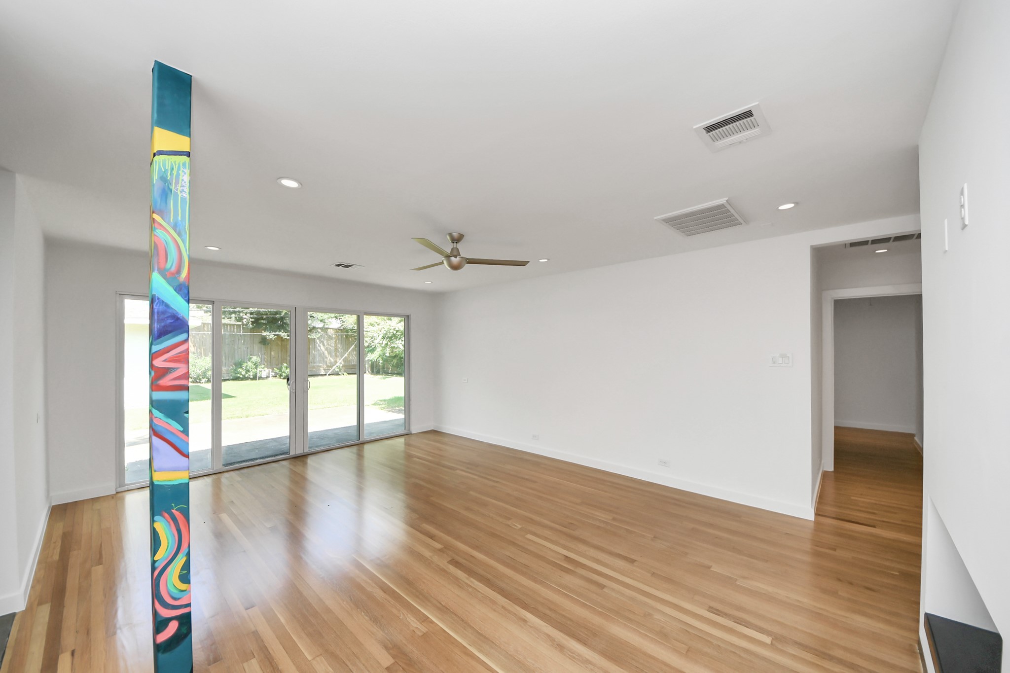 7610 Highmeadow Drive Houston, TX 77063 - Photo 39 of 50 an empty room with wooden floor and windows