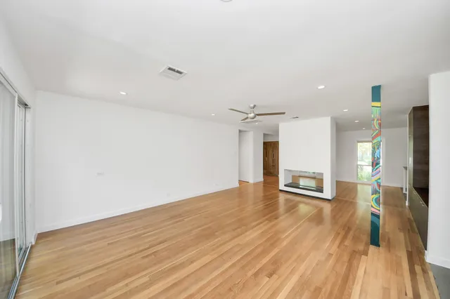 a view of a big room with wooden floor and closet