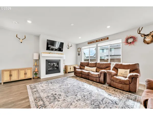 a living room with furniture a fireplace and a flat screen tv