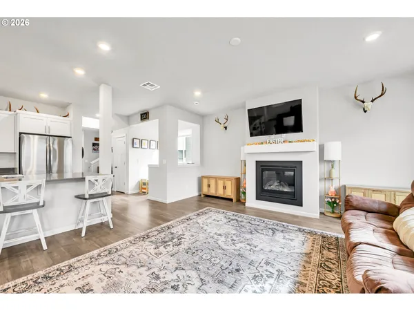 a living room with furniture and kitchen view
