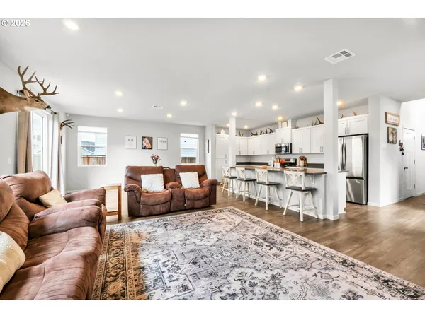 a large white kitchen with stainless steel appliances granite countertop a sink and cabinets