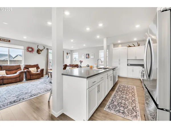 a large kitchen with kitchen island a sink a counter top space and cabinets