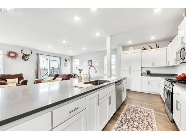 a kitchen with stainless steel appliances cabinets a sink and a counter