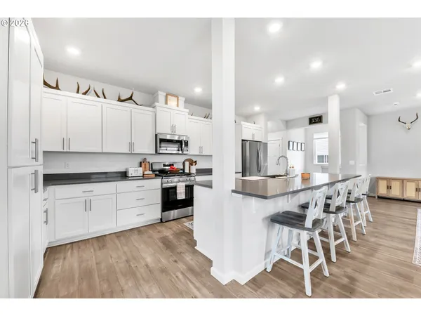 a kitchen with counter top space a sink stainless steel appliances and cabinets