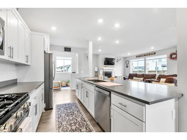 a kitchen with sink stove and refrigerator