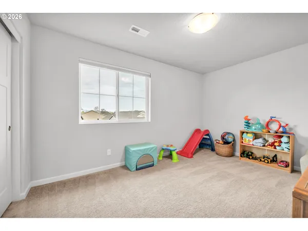 a bedroom with furniture and a book shelf