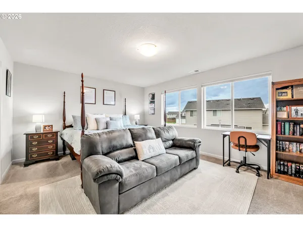 a bedroom with a bed furniture and a book shelf