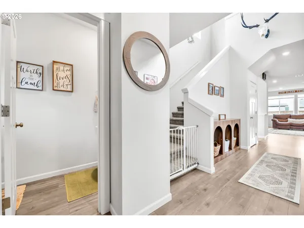a view of entryway and hall with wooden floor