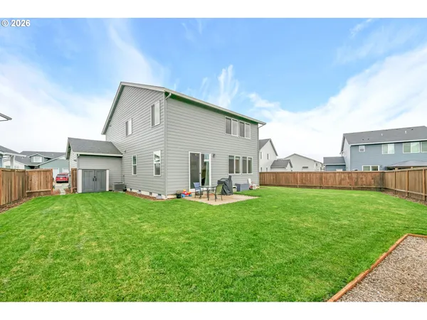 a backyard of a house with table and chairs