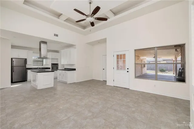 a view of kitchen with refrigerator and windows