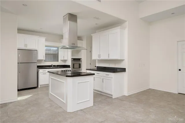 a kitchen with stainless steel appliances granite countertop a stove a refrigerator and a sink