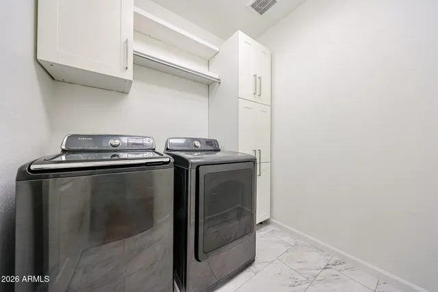 a utility room with dryer and washer