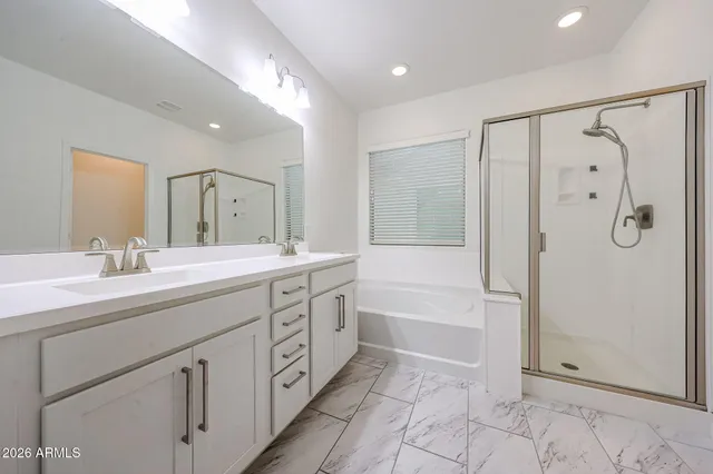 a spacious bathroom with a shower sink double and mirror