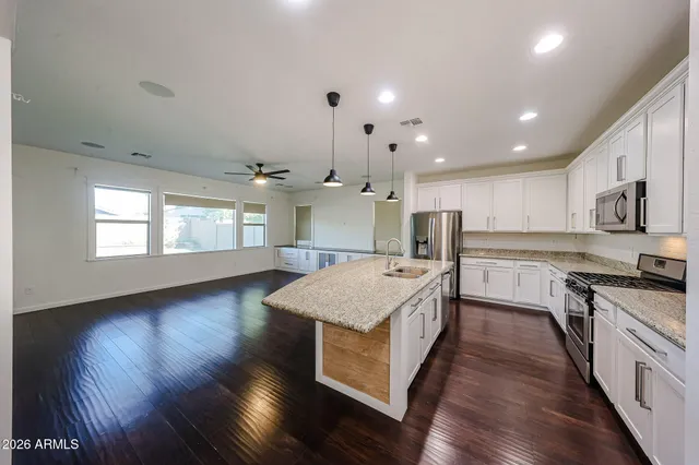 a kitchen with stainless steel appliances granite countertop a stove and a refrigerator