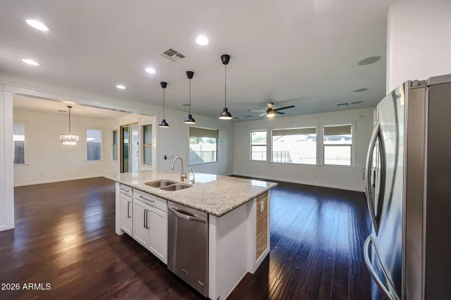 a kitchen with stainless steel appliances granite countertop a stove and a refrigerator