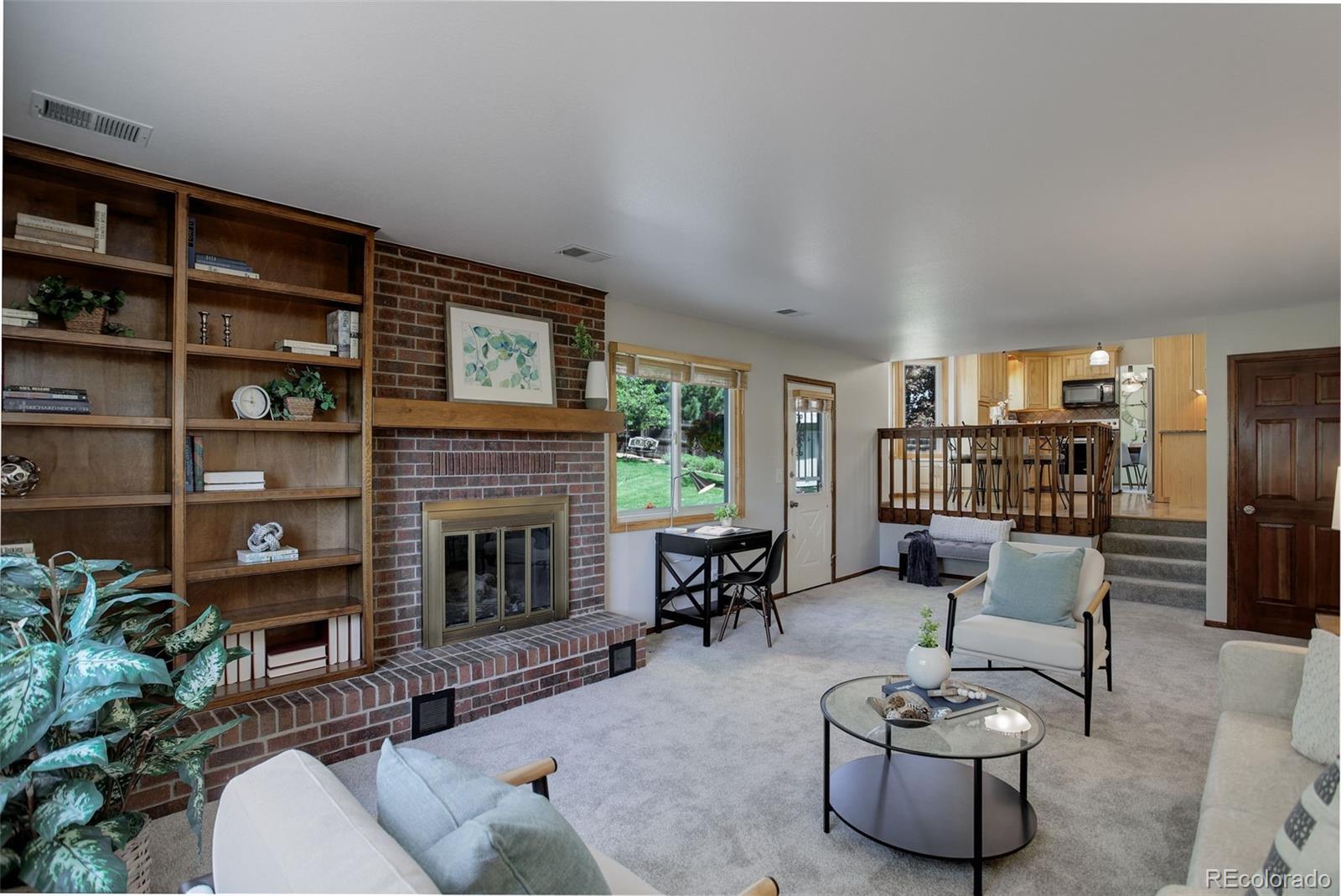 7877 West 110th Drive Westminster, CO 80021 - Photo 14 of 46 a living room with furniture and a fireplace