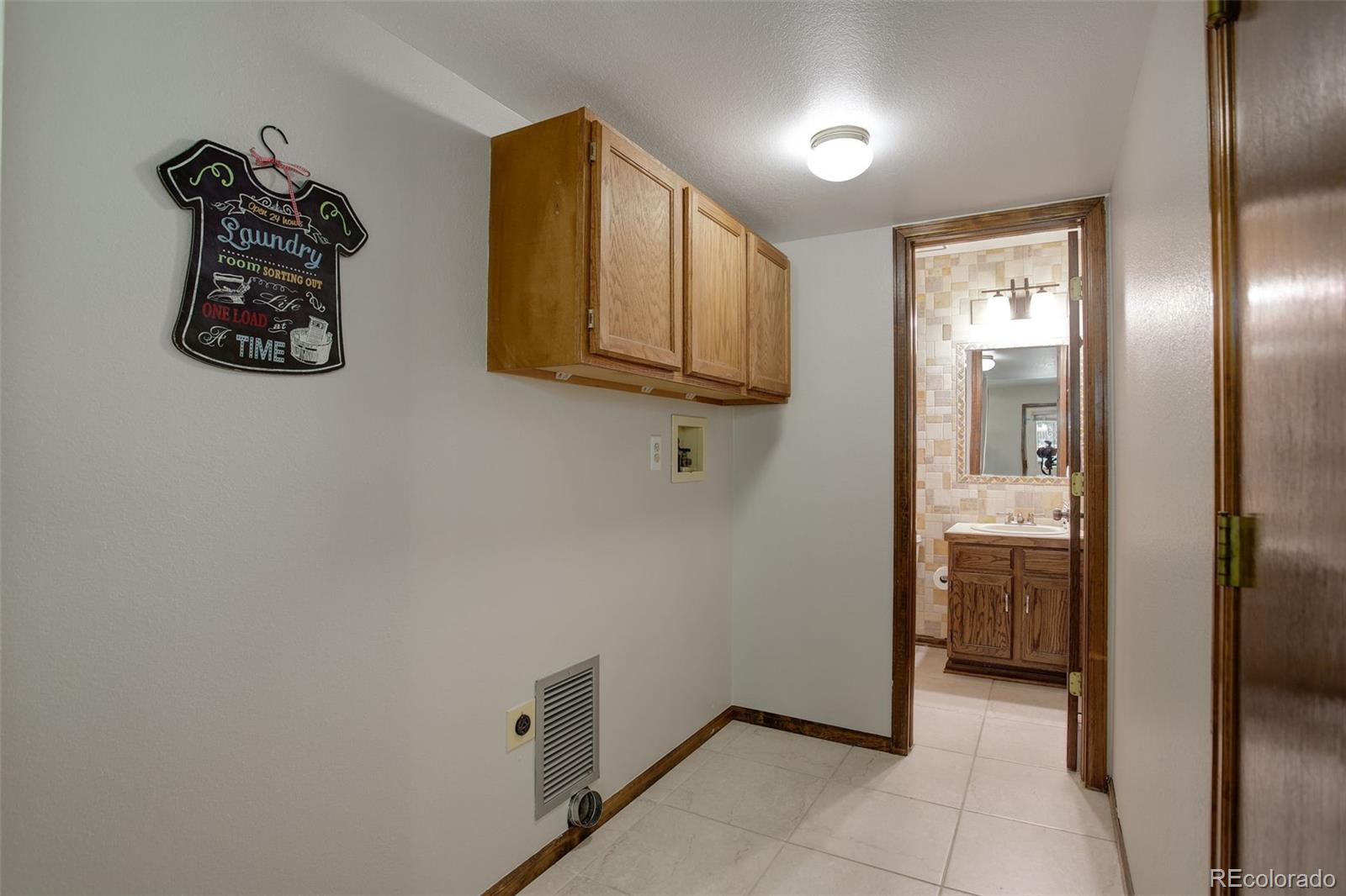 7877 West 110th Drive Westminster, CO 80021 - Photo 17 of 46 a view of a hallway to rooms and wooden floor