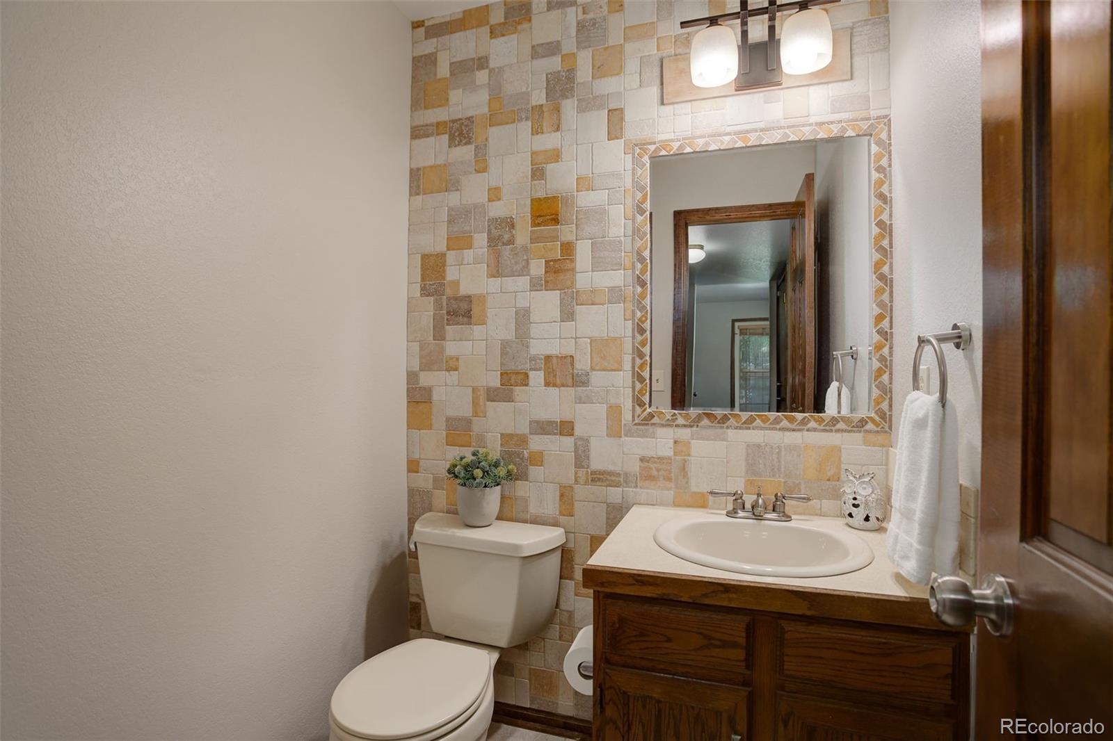 7877 West 110th Drive Westminster, CO 80021 - Photo 18 of 46 a bathroom with a toilet sink and mirror