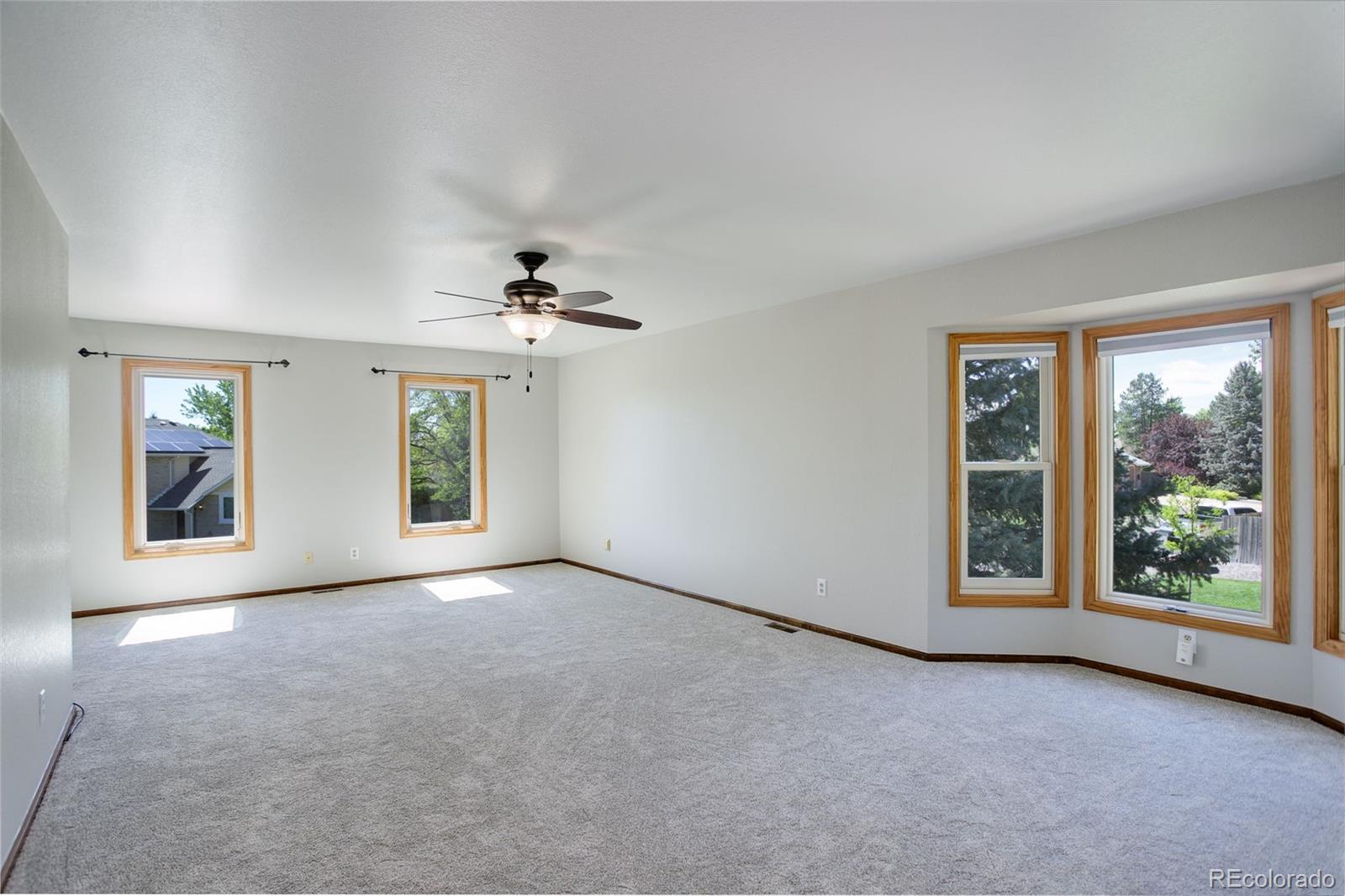 7877 West 110th Drive Westminster, CO 80021 - Photo 19 of 46 an empty room with windows and an entrance