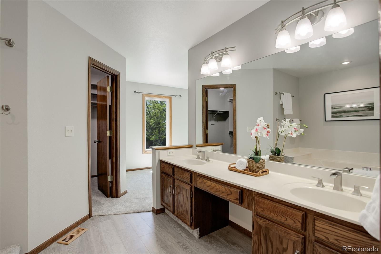 7877 West 110th Drive Westminster, CO 80021 - Photo 23 of 46 a bathroom with a sink double vanity and a mirror