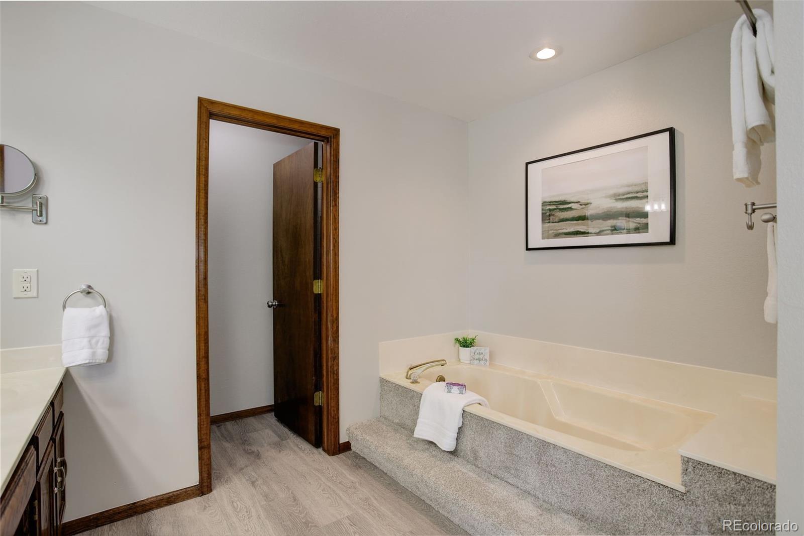 7877 West 110th Drive Westminster, CO 80021 - Photo 24 of 46 a bathroom with a tub and a shower