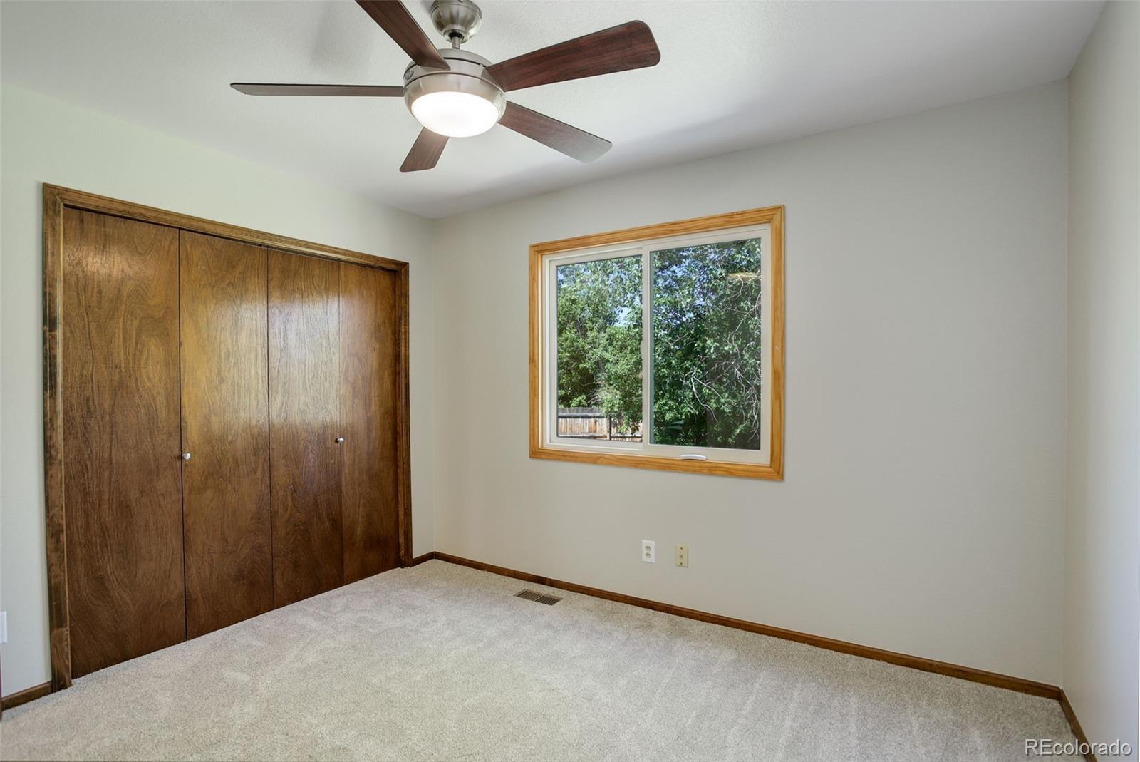 7877 West 110th Drive Westminster, CO 80021 - Photo 26 of 46 an empty room with windows and fan