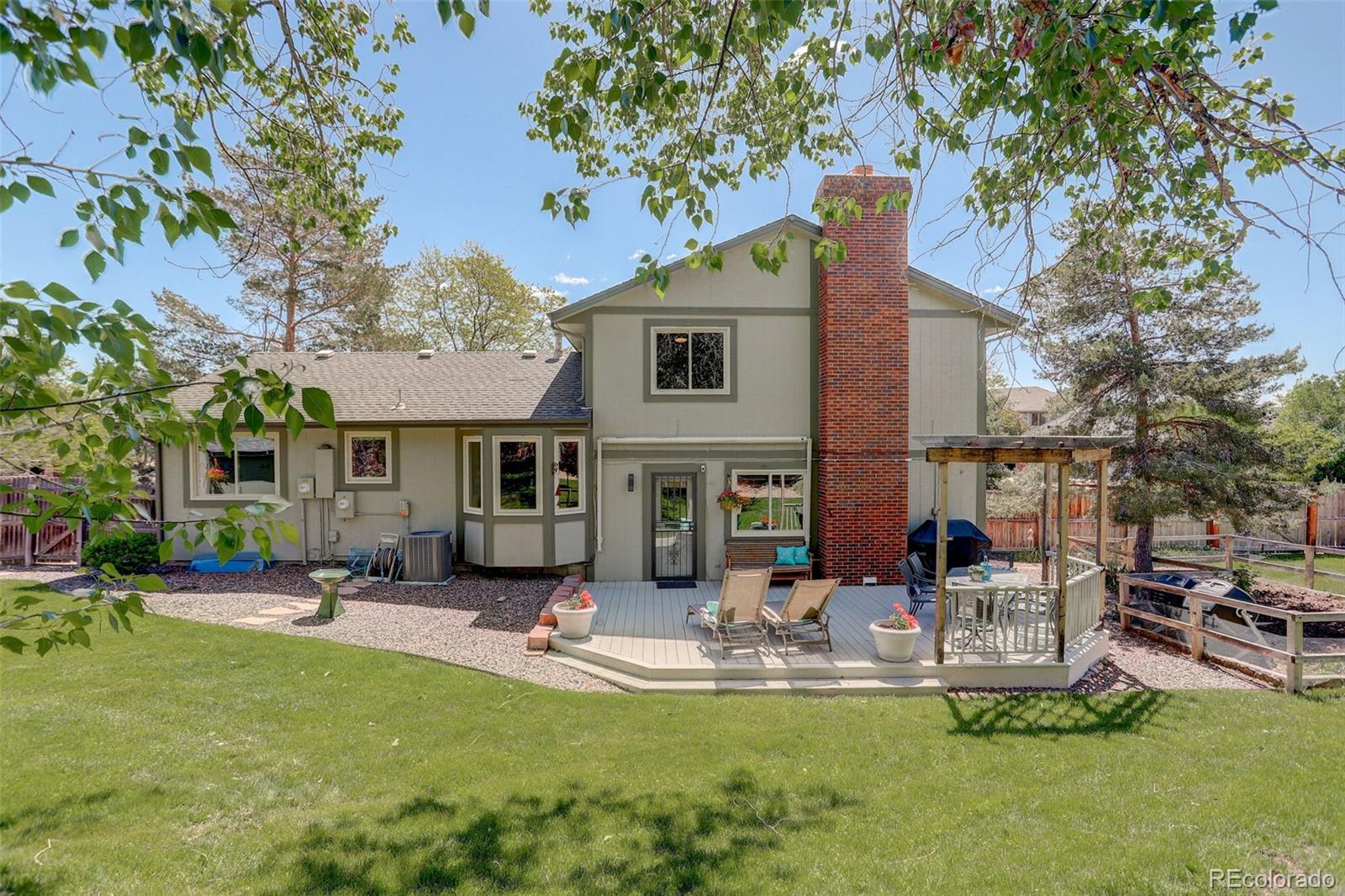 7877 West 110th Drive Westminster, CO 80021 - Photo 31 of 46 a front view of a house with swimming pool and sitting area