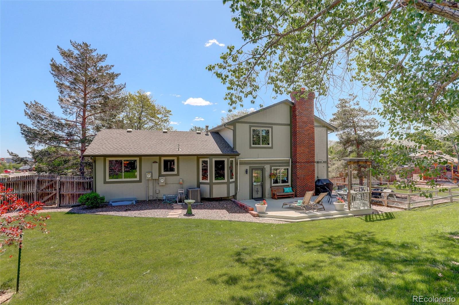 7877 West 110th Drive Westminster, CO 80021 - Photo 33 of 46 a front view of a house with garden and sitting area