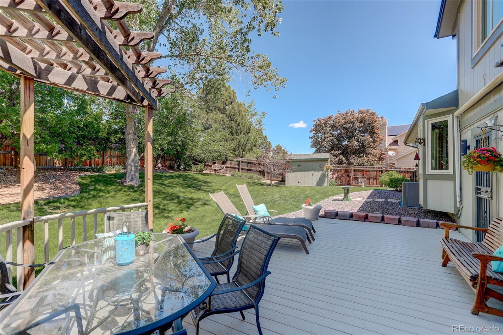 7877 West 110th Drive Westminster, CO 80021 - Photo 35 of 46 a view of a chairs and table in patio with a yard