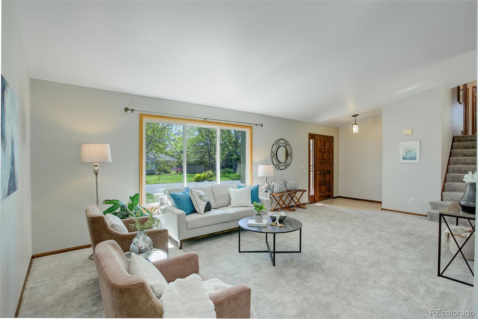 7877 West 110th Drive Westminster, CO 80021 - Photo 4 of 46 a living room with furniture and a large window
