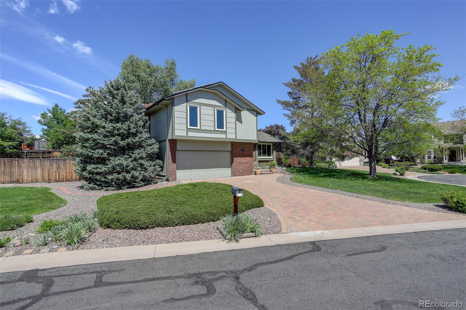 7877 West 110th Drive Westminster, CO 80021 - Photo 41 of 46 a front view of a house with a yard and garage