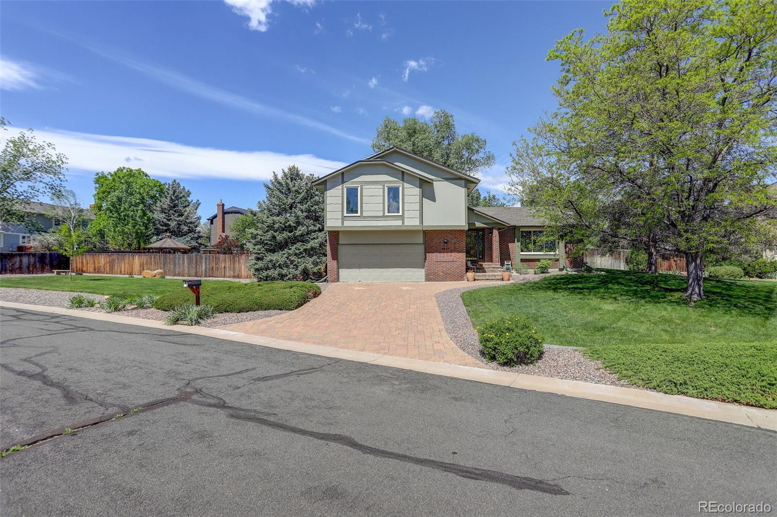 7877 West 110th Drive Westminster, CO 80021 - Photo 42 of 46 a front view of a house with a yard and garage