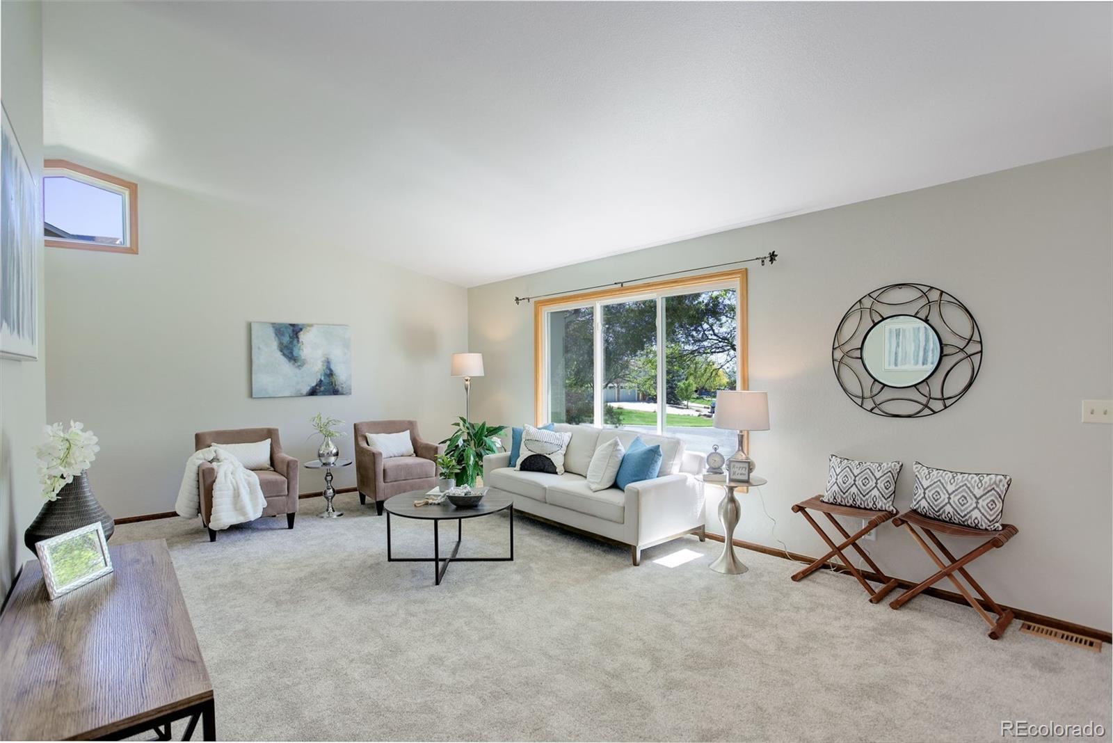 7877 West 110th Drive Westminster, CO 80021 - Photo 5 of 46 a living room with furniture a rug potted plant and a large window