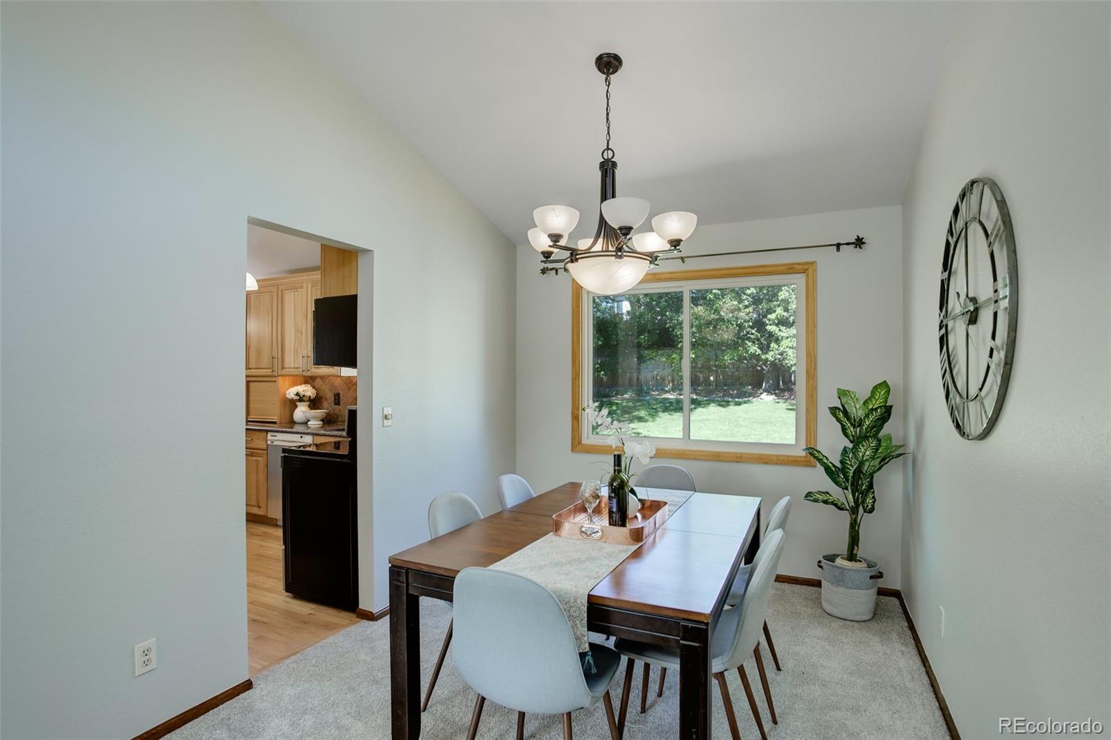 7877 West 110th Drive Westminster, CO 80021 - Photo 8 of 46 a view of a dining room with furniture window and wooden floor