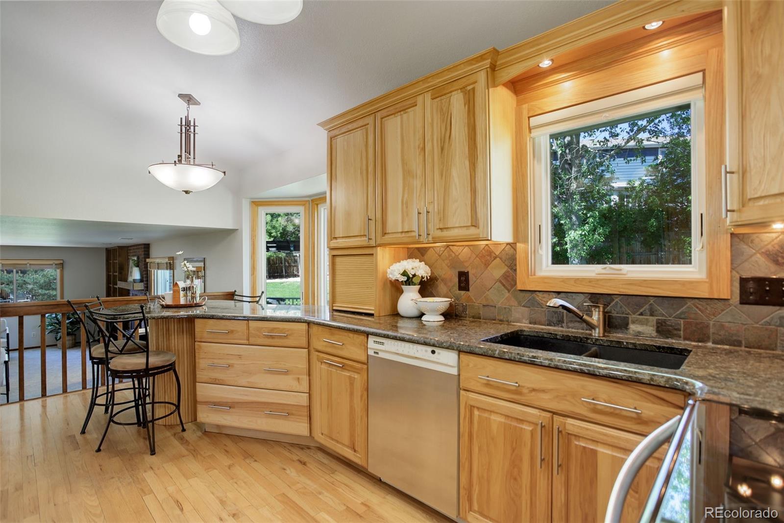 7877 West 110th Drive Westminster, CO 80021 - Photo 10 of 46 a kitchen with a sink stove and cabinets