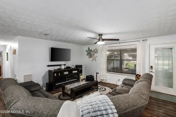 a living room with furniture and a flat screen tv