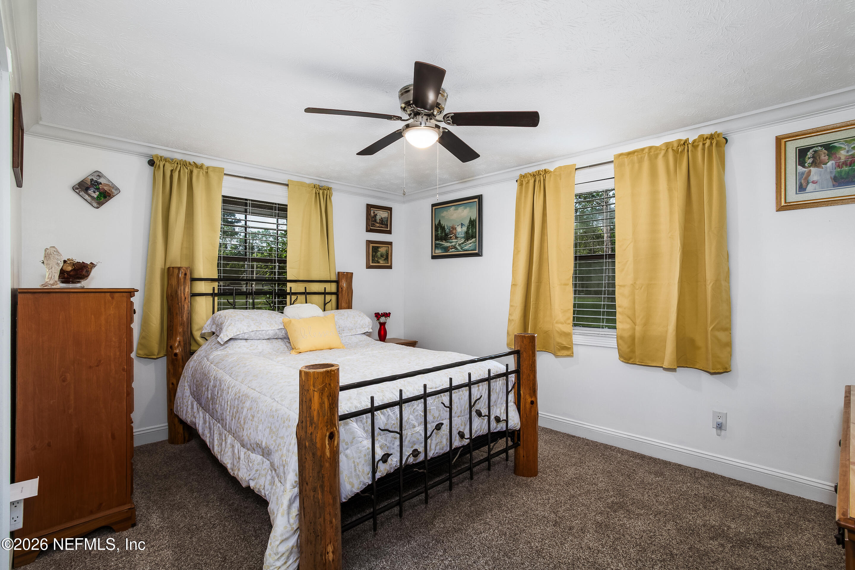 11401 Old Plank Road Jacksonville, FL 32220 - Photo 16 of 42 a bedroom with a bed and a chandelier