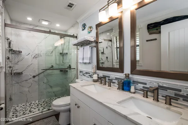 a bathroom with a sink toilet and shower